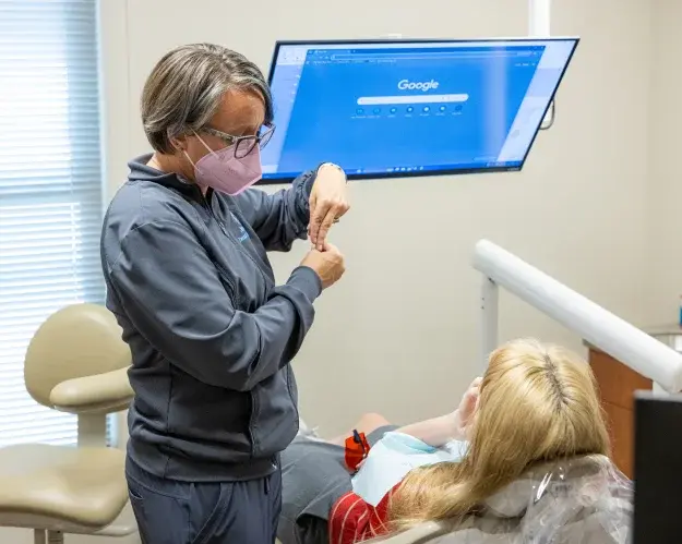Dentist consulting with patient about cosmetic dental treatment in Champaign office.