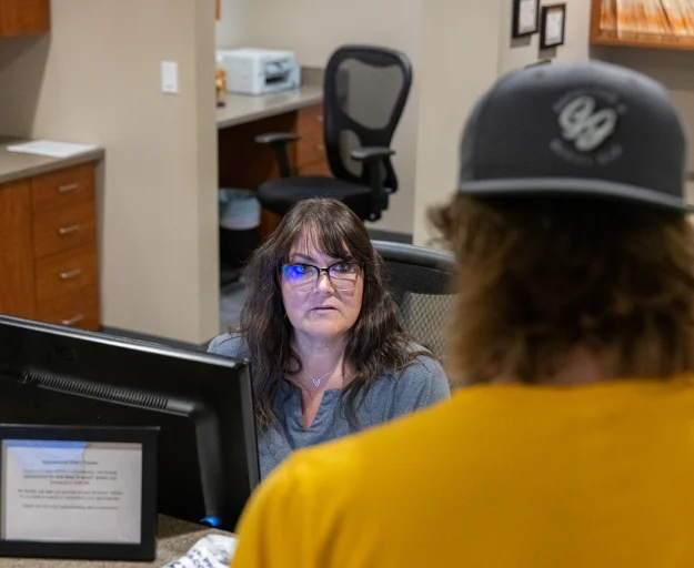 Front desk team member assisting a patient at W. Eric Martin, DDS, PC
