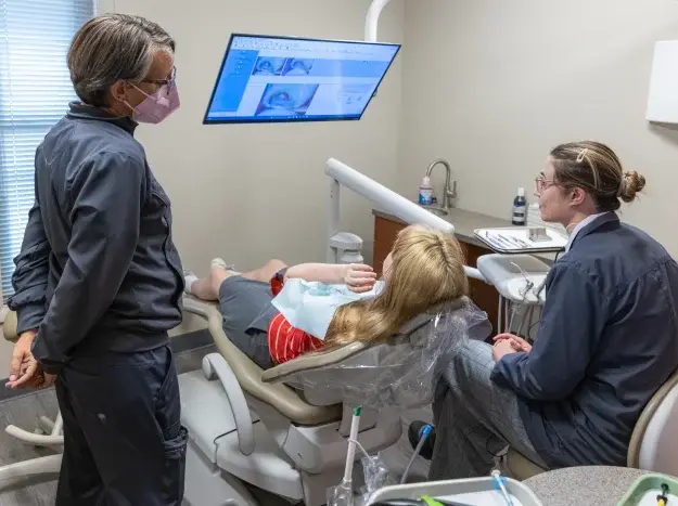 Dental team reviewing intraoral images on a screen with a patient at W. Eric Martin, DDS, PC